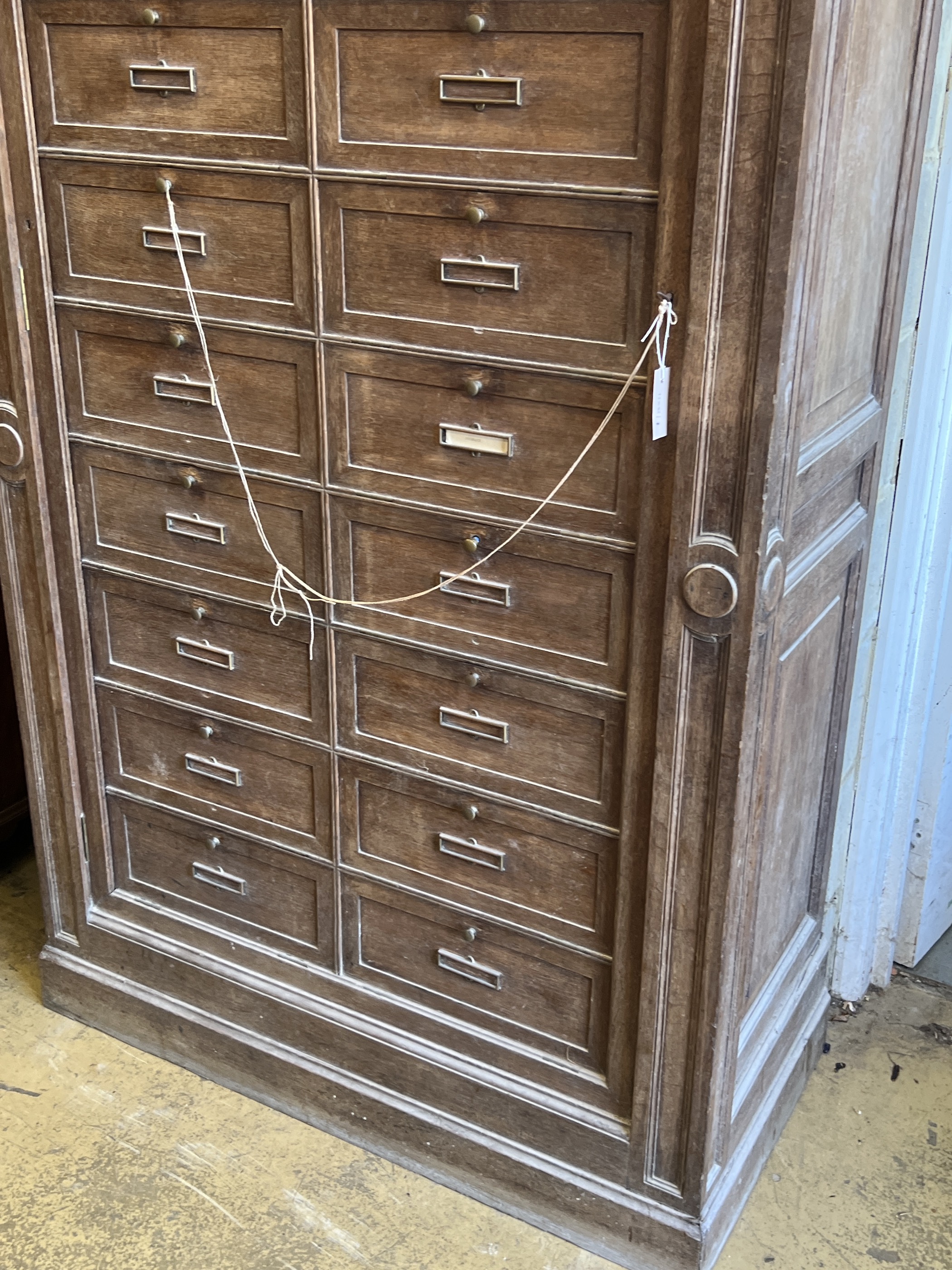 An early 20th century French oak notaries cabinet with 20 fall front compartments, width 125cm, depth 60cm, height 240cm